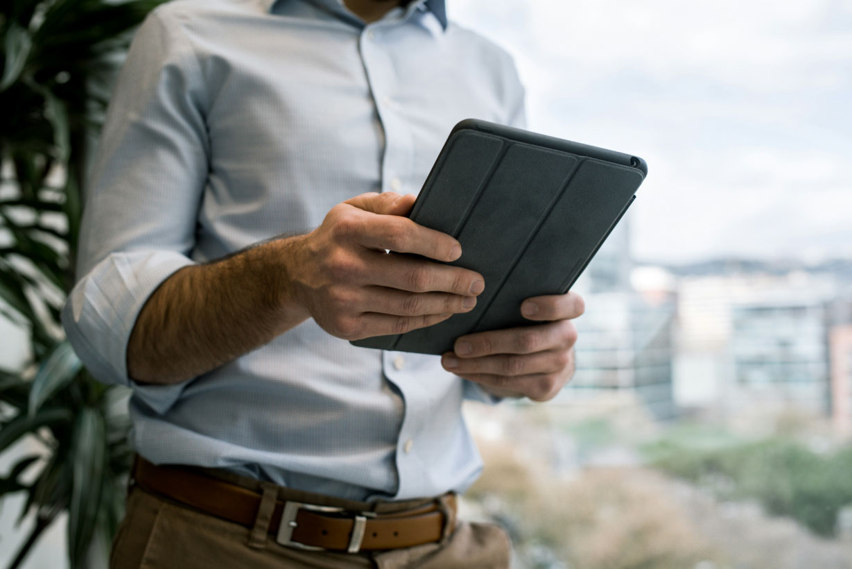 How to use technology to personalise guest experience (without losing the human touch) body image showing a guest using a hotel app on their iPad