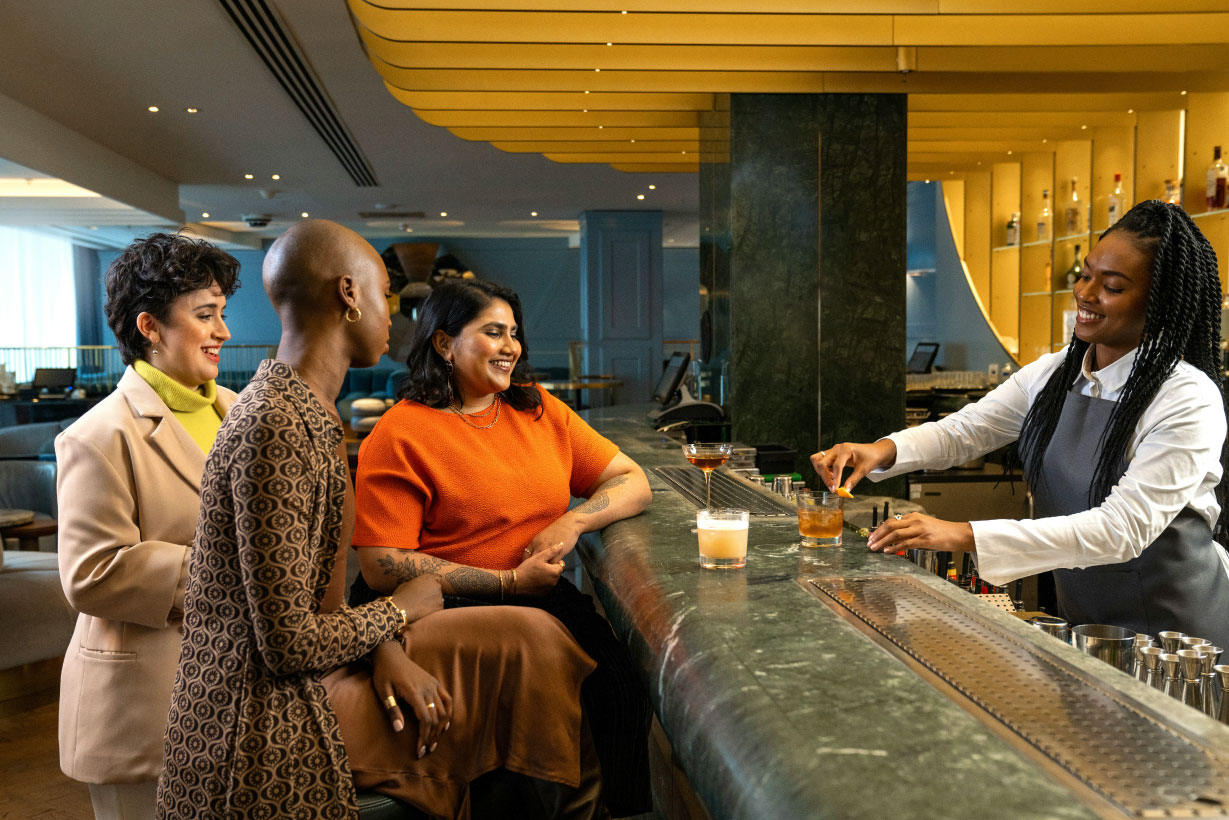 The 30-second Wi-Fi test: Why guests judge your hotel before they’ve unpacked body image showing a group of friends using a hotel bar